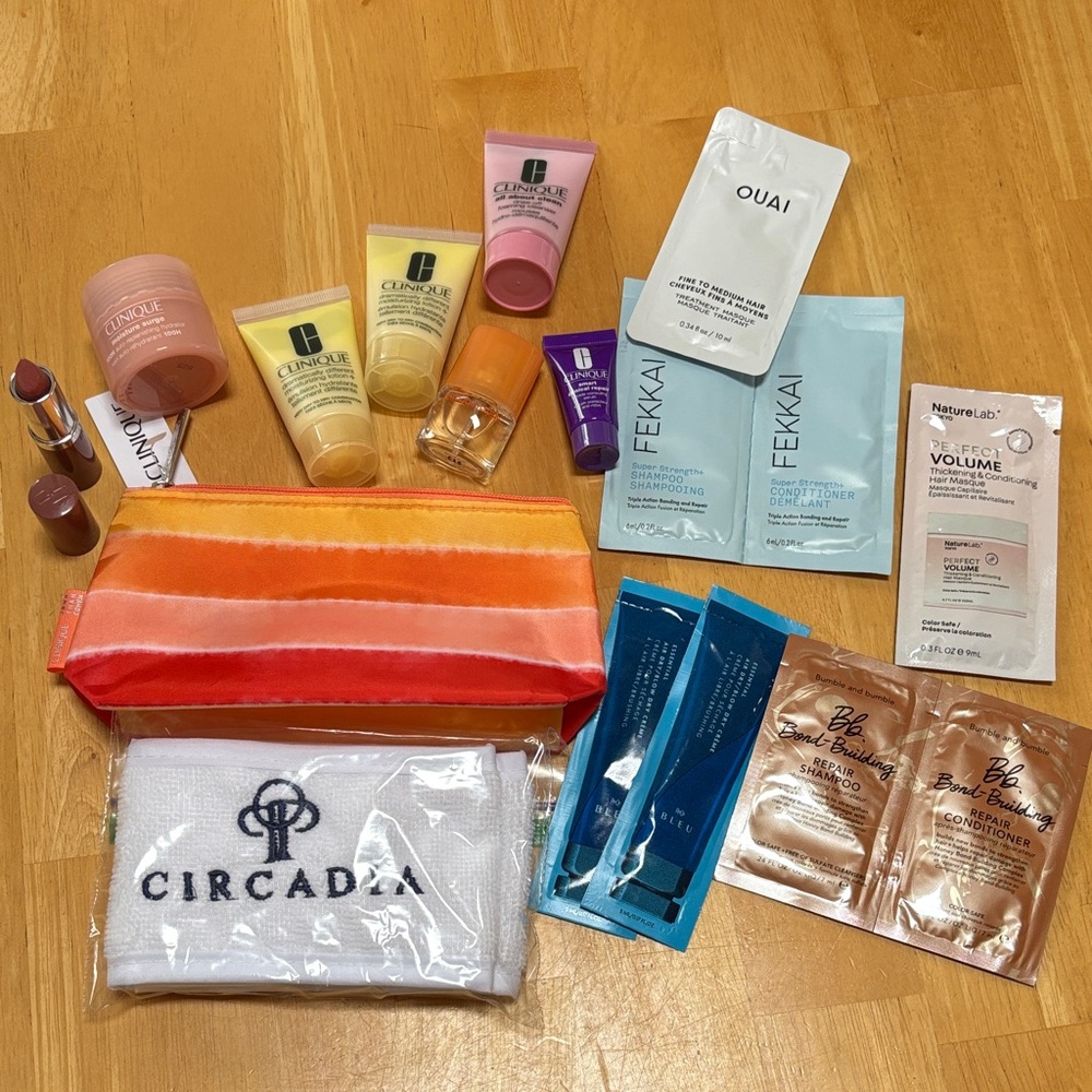 NEW Clinique & Assorted Beauty Sample Set with Striped Cosmetic Bag.
